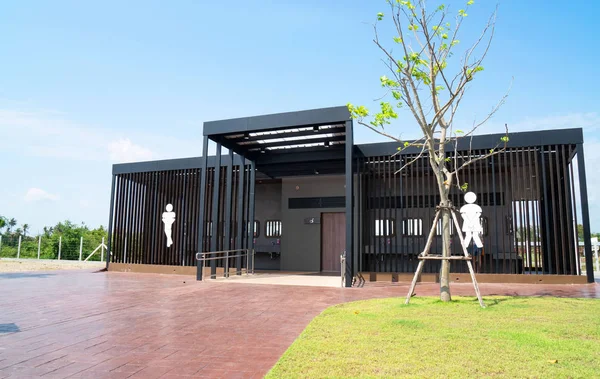 Modern Toilet metal building ,outdoor , day time , and blue sky background .