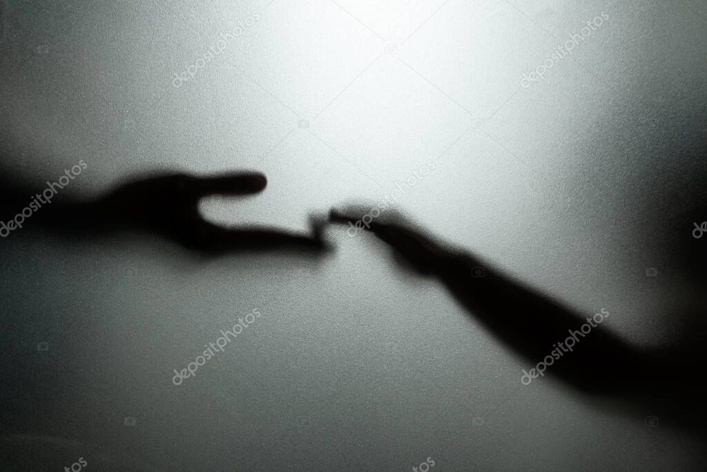 Ghost concept shadow of hand behind the matte glass blurry hand and body soft focus