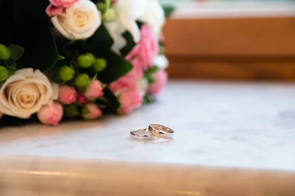 Gold wedding rings on the stand for rings