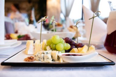 Plate with cheese on the table in restaurant