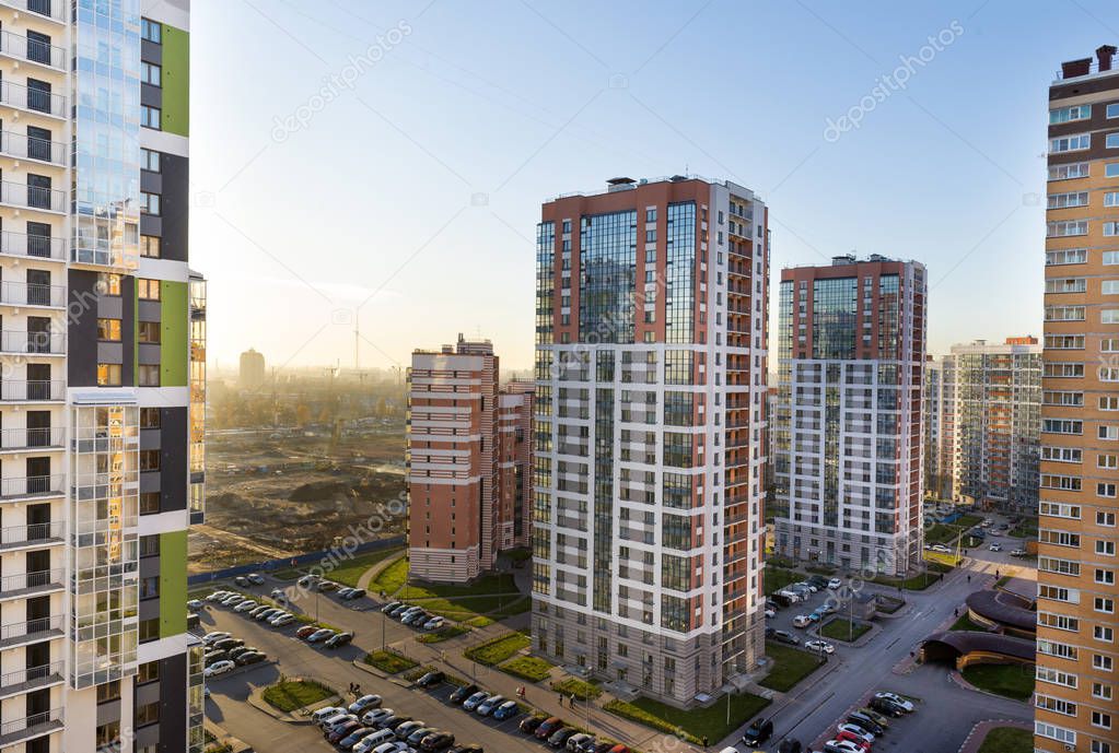 view of the residential area of St. Petersburg at sunset, modern buildings, Parking, cars, new buildings