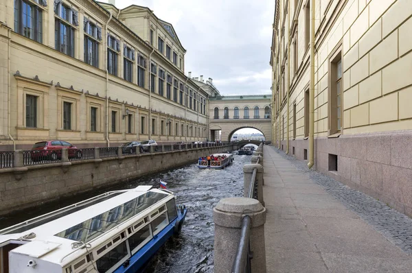 water channel with pleasure boats between the buildings of the Hermitage in St. Petersburg