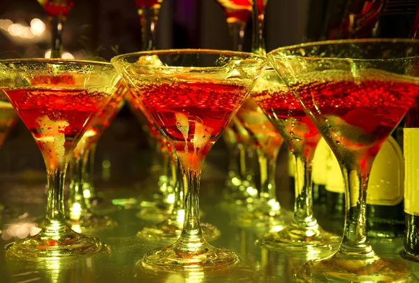 glasses of champagne with bubbles in red light, alcoholic drink