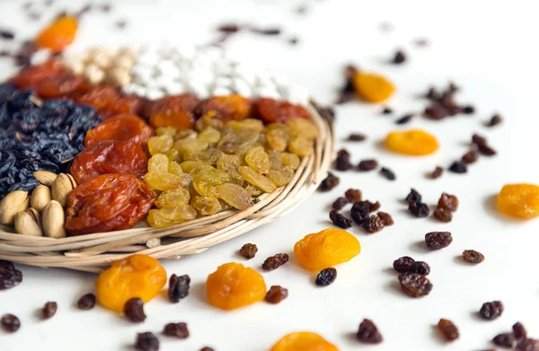 dried fruits, dried apricots,  raisins, , nuts, dried grapes, dried peaches on white background