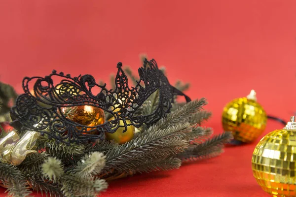 1 black lace mask fir Christmas wreath, gold Christmas balls on red background