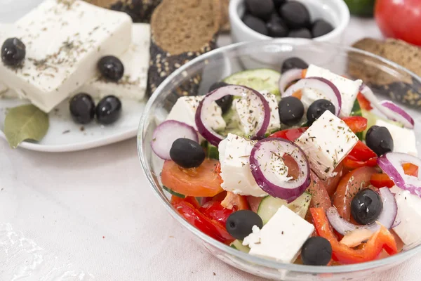 Greek vegetable salad with tomatoes, onions, cucumbers, olives, feta