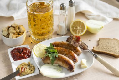 Ketçap, hardal, hafif bira, ekmek, çatal, sarımsak, soğan ile kızarmış sosis