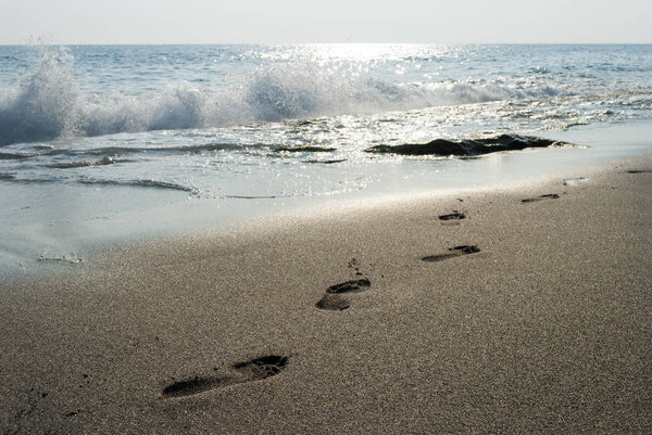 footprints in the sand on the sea coast, beach