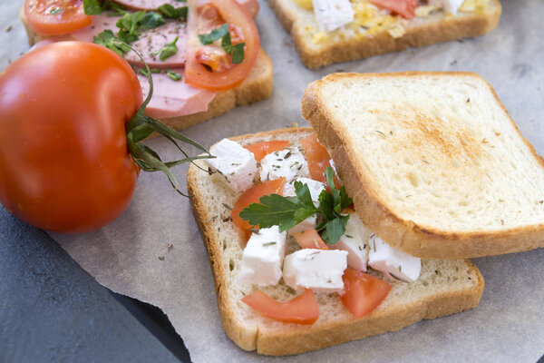 sandwich with feta ,tomatoes and parsley, bread with Greek chees