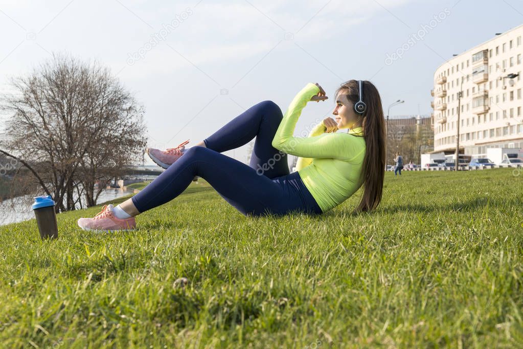 girl in green sports top engaged in fintess on the lawn in the c