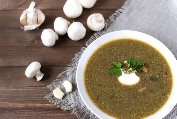 Mushroom soup with sour cream and a sprig of parsley, champignon — Stock Image Mushroom soup with sour cream and a sprig of parsley, champignon Royalty Free Stock Images