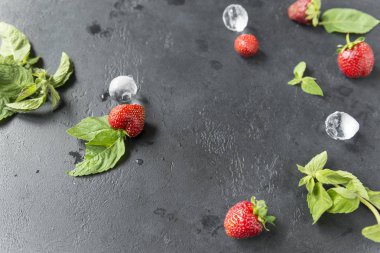 nane yaprakları, siyah arka plan üzerinde buz parçaları ile çilek