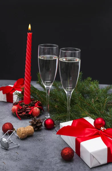 2 glasses of sparkling wine, champagne, red candle, gift box wit