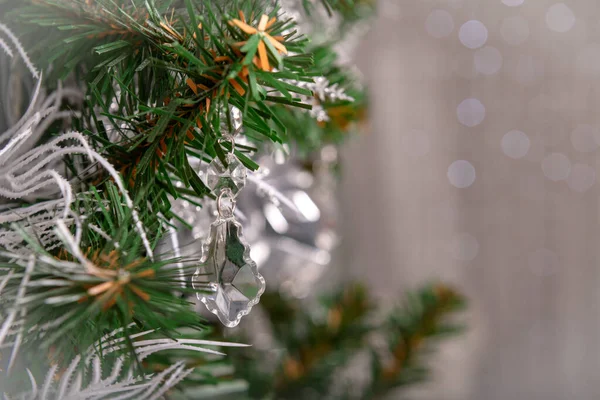 silver and transparent decorations and lights on the Christmas tree, decor