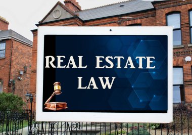 the words real estate law on a digital tablet