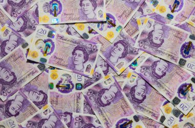 20 İngiliz sterlin banknotları, finans, tasarruf, ticaret ve İngiltere ekonomisini sembolize eden bir para arkaplanı oluşturmaktadır.