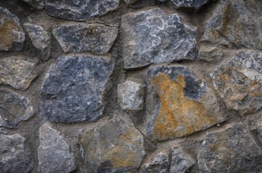 Kıbrıs Rum Kesimi 'nin doğal taş duvar dokusunun yakın çekimi. İç tasarım ve ev dekorasyonu projeleri için Rustik dekoratif arka plan mükemmel.