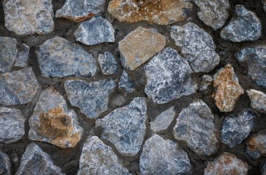 Kıbrıs 'tan gelen taş duvarın ayrıntıları. Tasarım ve inşaat projeleri için ideal, doğal duvarcılık ile Rustik Akdeniz mimari arka planı.