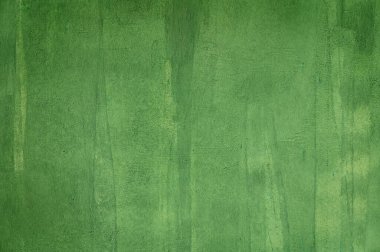 Çatlakları ve dokuları gösteren eski yeşil boyayla boyanmış bir duvar. Kırsal ve klasik arka plan tasarım, iç mekan ve sanatsal kavramlar için mükemmel.