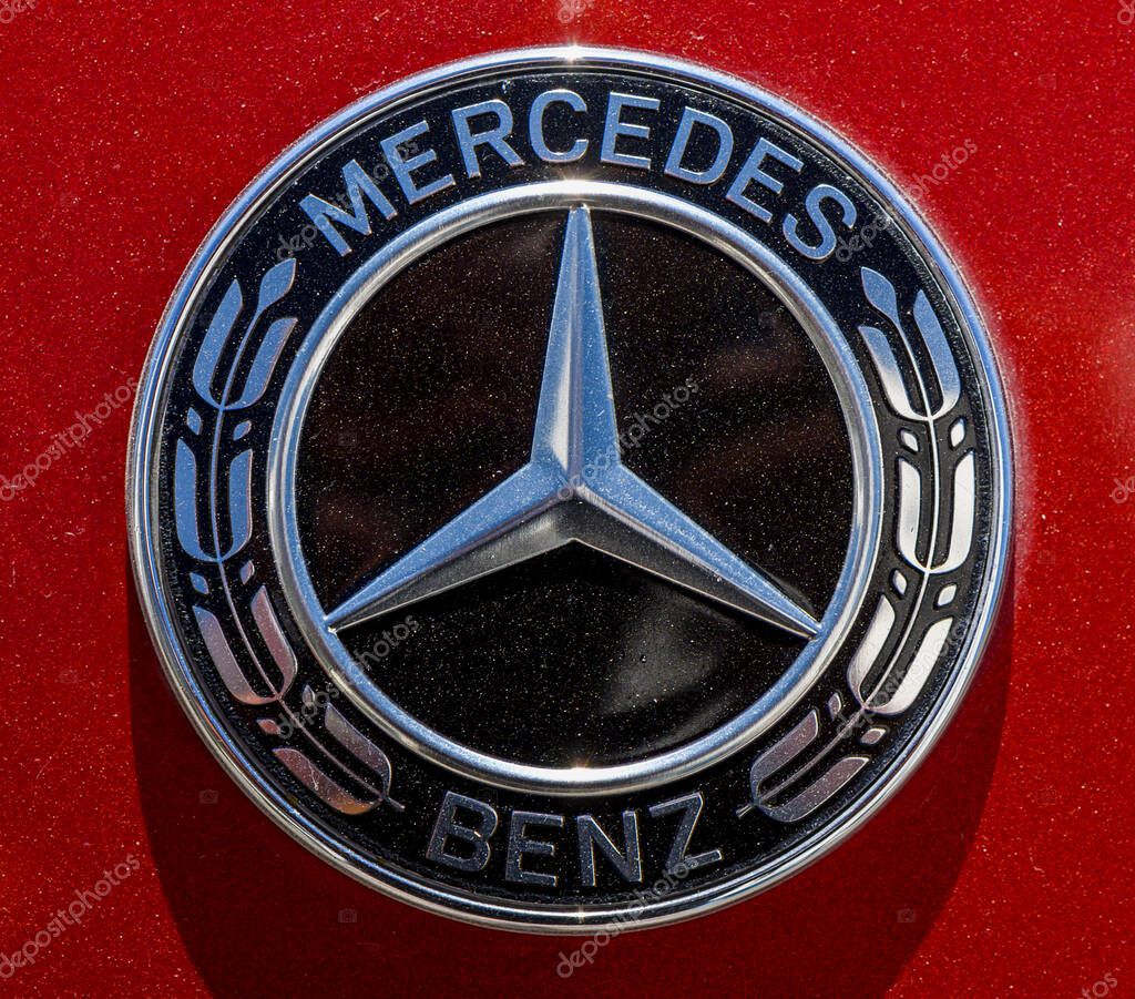 Gaziveren ,Cyprus 09.21.2025 Close-up of the Mercedes-Benz emblem on a shiny red car hood, perfect for automotive, luxury, and brand stock photography.