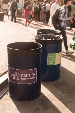 Kyiv / Ukraine - June 19, 2018: In the picture - garbage cans for separate rubbish for further processing. clipart