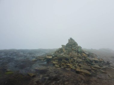 Üstünde sis le çevrili çamurlu zeminde taş yığını