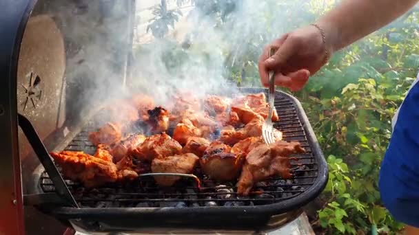 Close Male Hands Baking Meal Outdoors Grill Using Fork Turning — Stock Video
