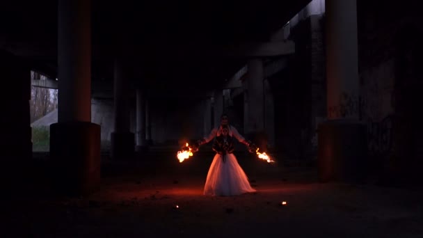 A Couple In Wedding Dresses And With Skull Makeup Perform A Fire