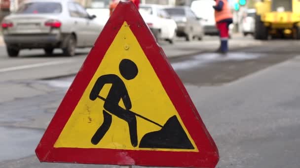 Roadworks signs on a street. Workers put new asphalt in the city on the road. — Stock Footage Roadworks signs on a street. Workers put new asphalt in the city on the road. Video Clip