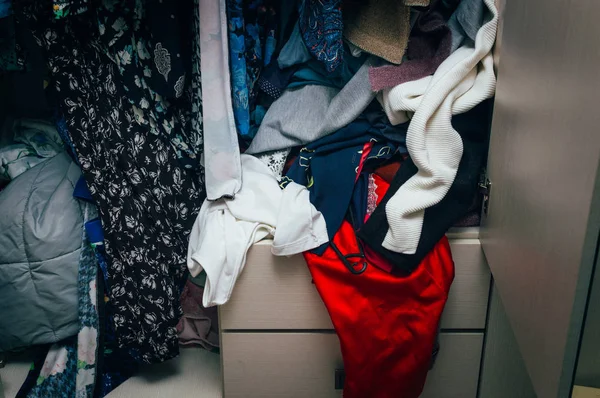 Mess in the closet. Scattered female things. The concept is nothing to wear a woman.