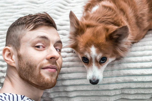 Genç bir adam ve bir köpek. Portre portre. Kırmızı köpek ve kırmızı adam