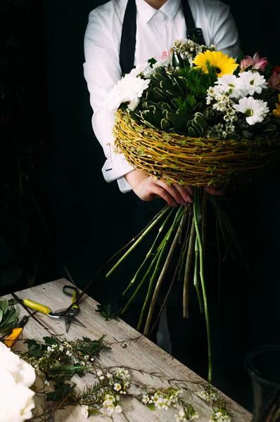 process of creating a creative large bouquet of flowers. Vertical photo. Concept floristics