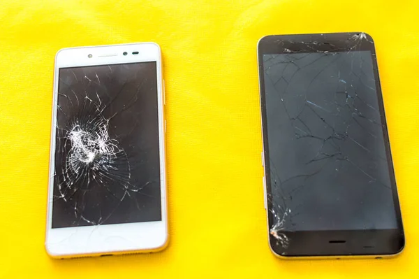 Concept broken phone. Smartphone repair concept. Two broken screens of mobile phones