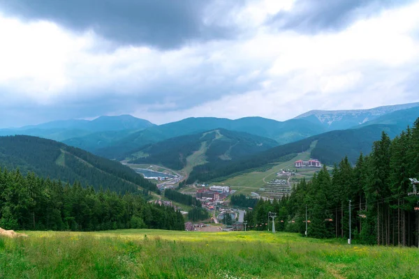 Mountain forest landscape under evening sky with clouds in sunlight. Majestic mountains landscape under morning sky with clouds. Overcast sky before storm. Carpathian, Ukraine, Europe.