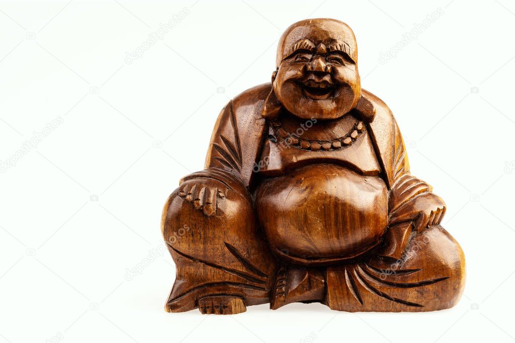 isolated wooden statuette of a happy buddha on a white background