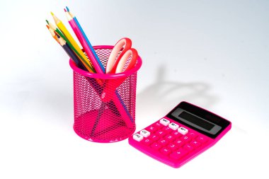 bir hesap makinesi ve pembe bir kap içinde renkli kalemler ile Okul arka plan