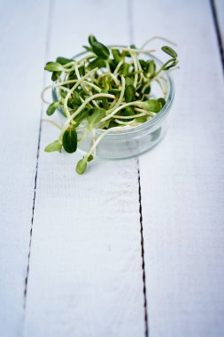 Yeşil Beyaz ahşap bir masa üzerinde kase şeklinde bir kalbinde ayçiçeği lahanası