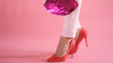 kadınsı ve zarif yürüyüş sırasında çanta ile mercan arka planda kadın bacaklar