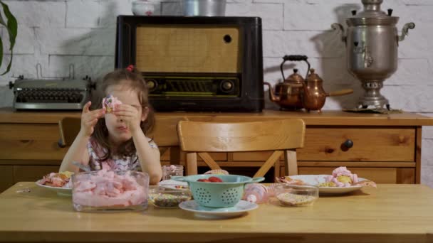 Küçük kız süsler ve lezzetli cupcakes yiyor — Stok video