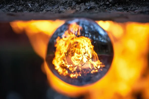 Visão invertida através da bola de lente na fogueira turva na floresta — Fotografia de Stock