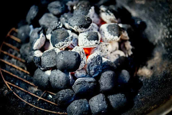 Closeup de carvão brilhante na grade de metal no dia de verão no jardim — Fotografia de Stock