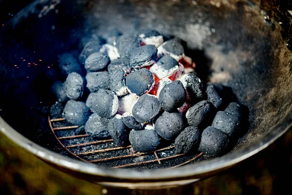 Zbliżenie świecącego węgla w metalowym grillu w letni dzień w ogrodzie — Zdjęcie stockowe