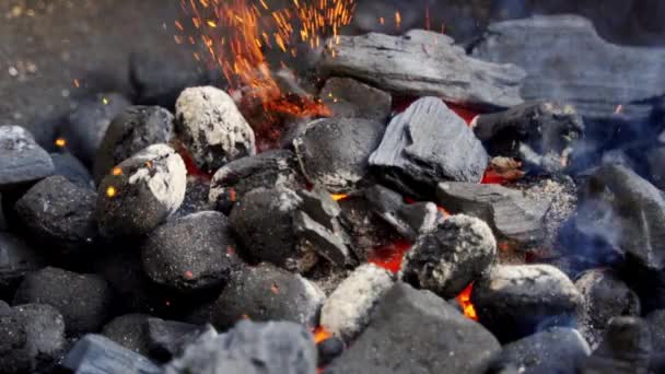 Closeup of glowing coal in metal grill on summer day in slow motion — Stock Video