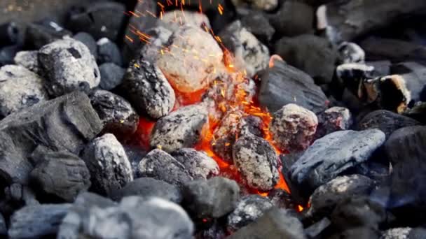 Closeup of glowing coal in metal grill on summer day in slow motion — Stock Video
