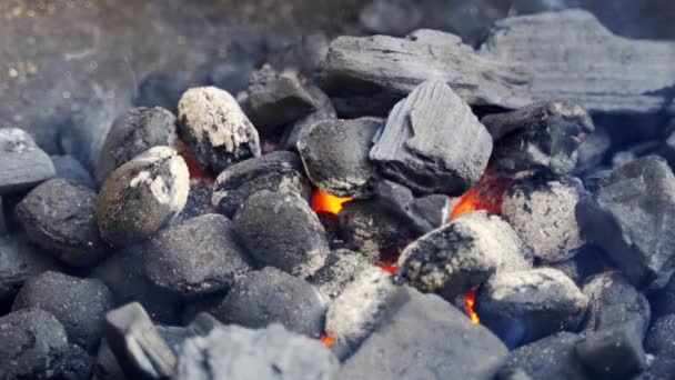 Closeup of glowing coal in metal grill on summer day in slow motion — Stock Video