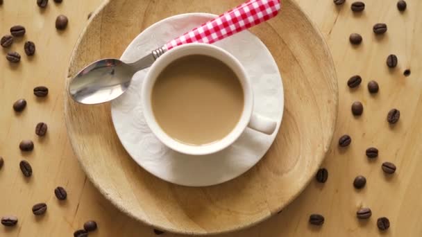 Top uitzicht van koffie met lepel op decoratieve plaat op houten tafel — Stockvideo