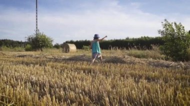 Çavdar tarlasında yürüyen tatlı küçük kız. 