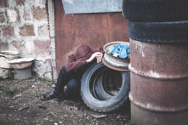 Caucasian homeless man sitting and thinking. 