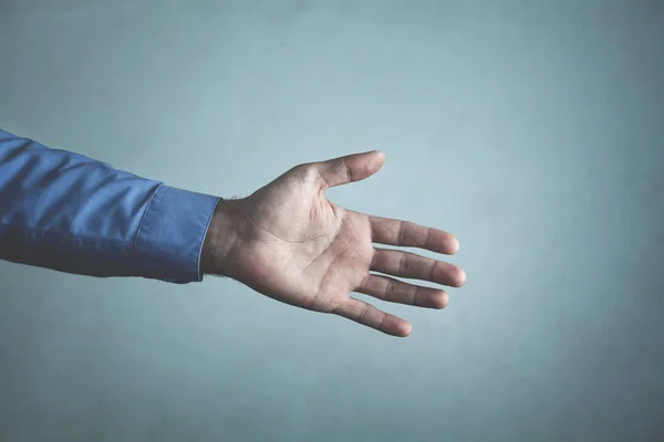 Businessman offering hand for handshake. Deal concept