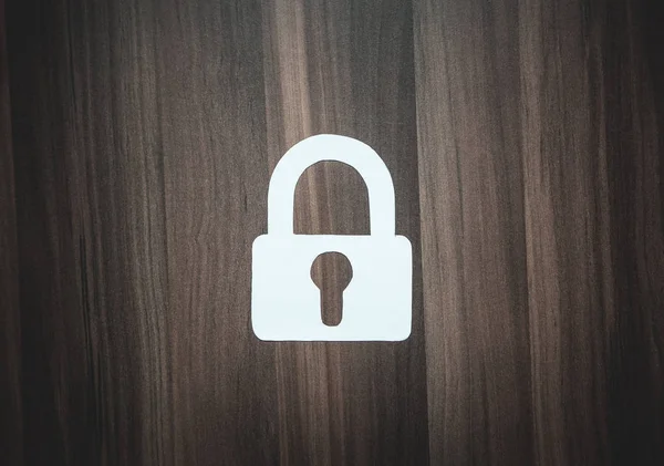 Paper padlock on wood background. Security concept